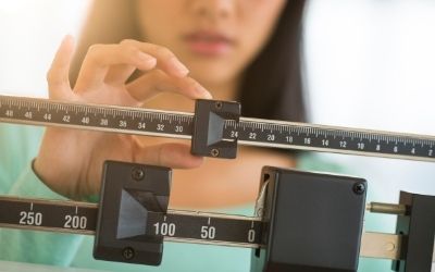 woman on scale measuring weight